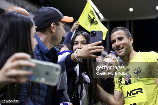 Tomer Hemed of the Phoenix poses with the crowd as he celebrates victory after scoring an injury time goal during the A-League match between the...