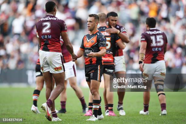 Luke Brooks of the Tigers shakes hands with Sea Eagles players after the round seven NRL match between the Wests Tigers and the Manly Sea Eagles at...