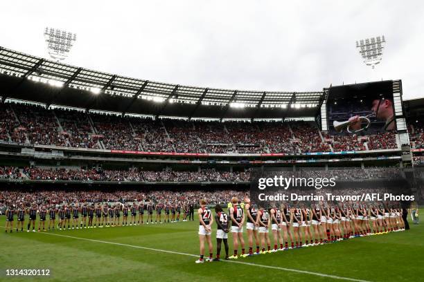 Essendon and Collingwood players line up for the ANZAC Day service before the round six AFL match between the Collingwood Magpies and the Essendon...