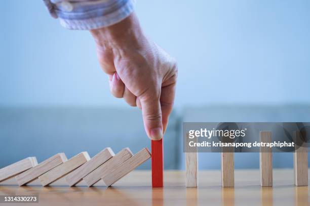 business man placing wooden block on a tower concept risk control, planning and strategy in business.alternative risk concept,risk to make buiness growth concept with wooden blocks - broken toy stock pictures, royalty-free photos & images