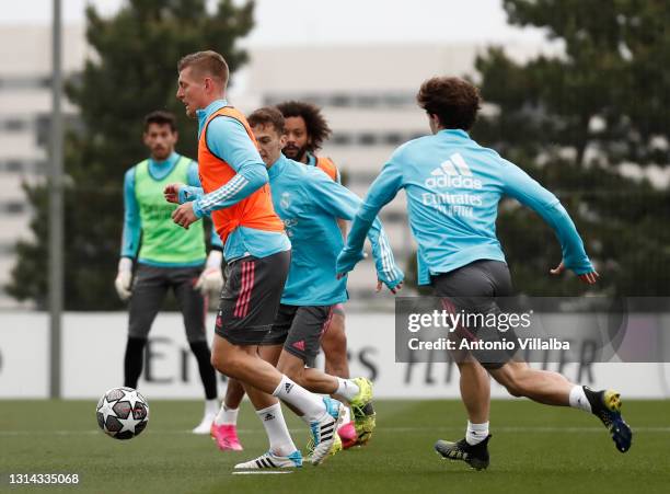 Toni Kross and Álvaro Odriozola both of Real Madrid are training with Marcelo Silva of Real Madrid at Valdebebas training ground on April 25, 2021 in...