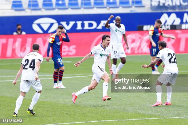 Enes Uenal of Getafe CF celebrates with Damian Suarez after scoring their side's second goal during the La Liga Santander match between SD Huesca and...