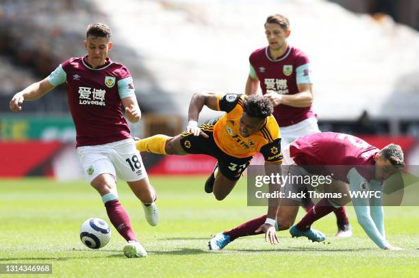 Adama Traore of Wolverhampton Wanderers is challenged by Matthew Lowton of Burnley during the Premier League match between Wolverhampton Wanderers...