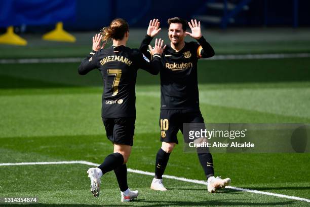Antoine Griezmann of FC Barcelona celebrates with Lionel Messi after scoring their side's first goal during the La Liga Santander match between...