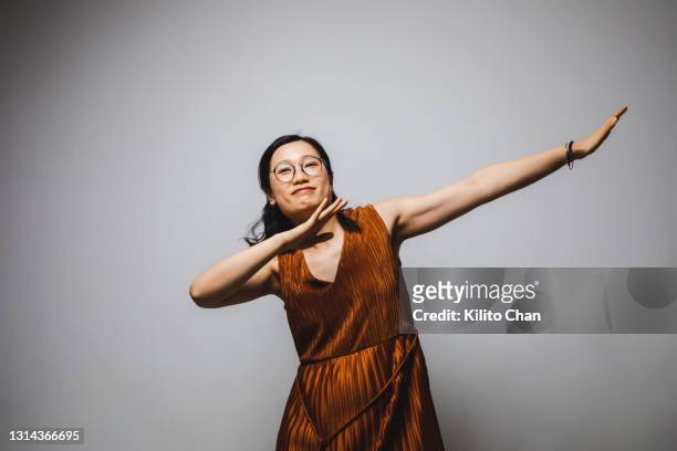 portrait of asian woman in a pretty dress dancing - 2021 a funny thing 個照片及圖片檔