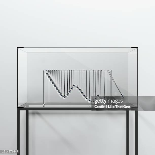 a chrome newtons cradle modelled to create a declining graph - perpetual motion stock pictures, royalty-free photos & images