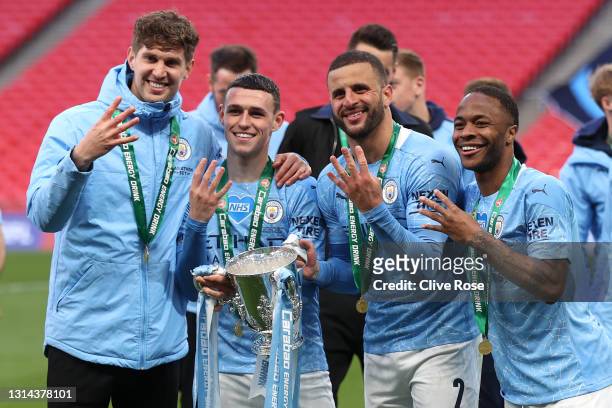John Stones, Phil Foden, Kyle Walker and Raheem Sterling of Manchester City celebrates with the trophy after winning the Carabao Cup after the...