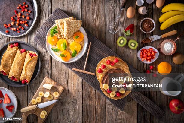 crepes arrangement with fruits, berries, cocoa cream and varied vegetarian food - nutella pancake stock pictures, royalty-free photos & images