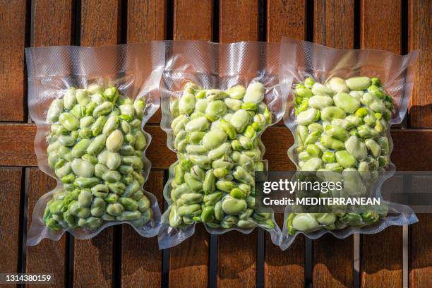 broad beans also lima beans peeled in vacuum sealed plastic bag ready to be frozen - frozen meal stock pictures, royalty-free photos & images