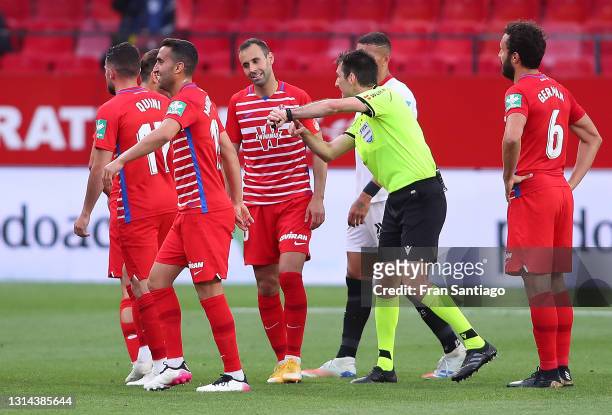 Players of Grenada FC protest as the referee only plays one of the four minutes added time during the La Liga Santander match between Sevilla FC and...