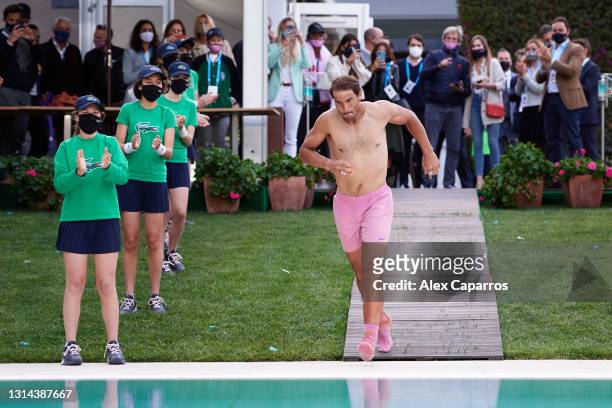 Rafael Nadal of Spain jumps into the pool after his victory against Stefanos Tsitsipas of Greece in their final match during day seven of the...