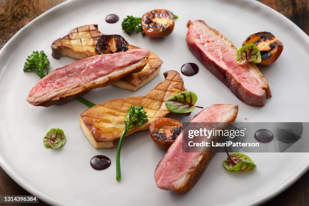 pan seared crispy duck breast with a beet gastrique - sears canada stock pictures, royalty-free photos & images