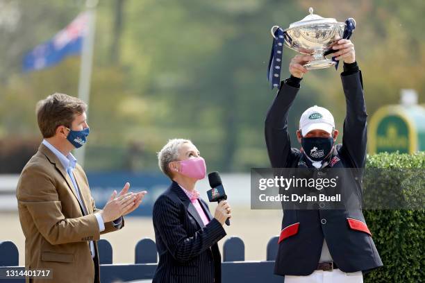 Oliver Townend of Great Britain celebrates with the trophy after winning the Stadium Jumping Phase of the Land Rover Kentucky Three-Day Event at the...