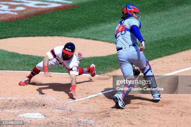 Adam Eaton of the Chicago White Sox slides into home during the second inning in the game against the Texas Rangers at Guaranteed Rate Field on April...