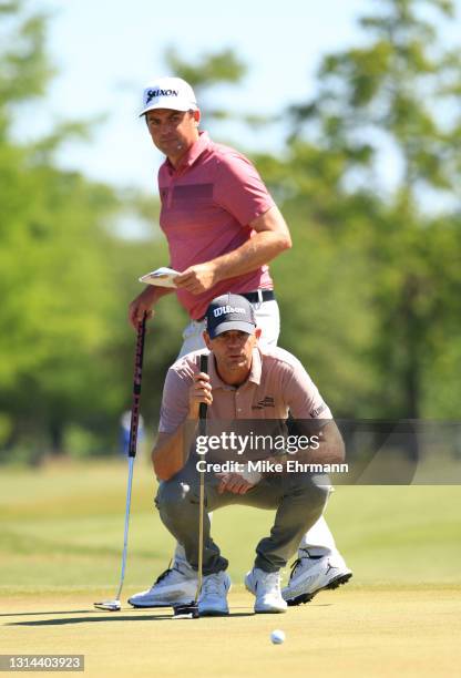 Keegan Bradley and Brendan Steele lines up a putt on the 13th green during the final round of the Zurich Classic of New Orleans at TPC Louisiana on...