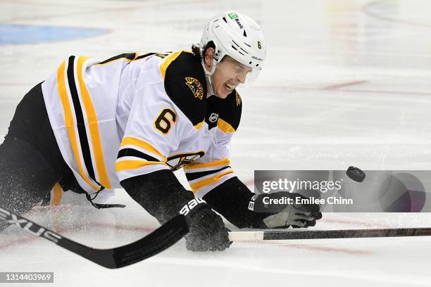 Mike Reilly of the Boston Bruins loses the puck as he falls on the ice in the second period during their game against the Pittsburgh Penguins at PPG...