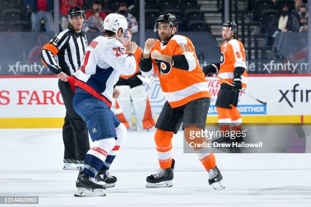 Garnet Hathaway of the Washington Capitals and Andy Andreoff of the Philadelphia Flyers fight in the first period at Wells Fargo Center on March 11,...