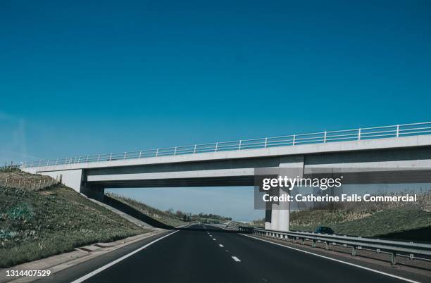large concrete bridge over a motorway - straight highway stock pictures, royalty-free photos & images