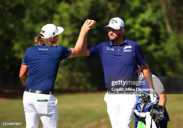 Cameron Smith of Australia and Marc Leishman of Australia react to a birdie putt on the 16th green during the final round of the Zurich Classic of...