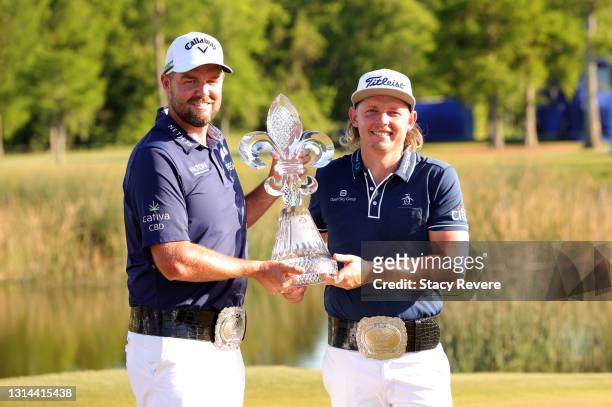 Marc Leishman of Australia and Cameron Smith of Australia pose with the trophy after winning in a playoff hole during the final round of the Zurich...