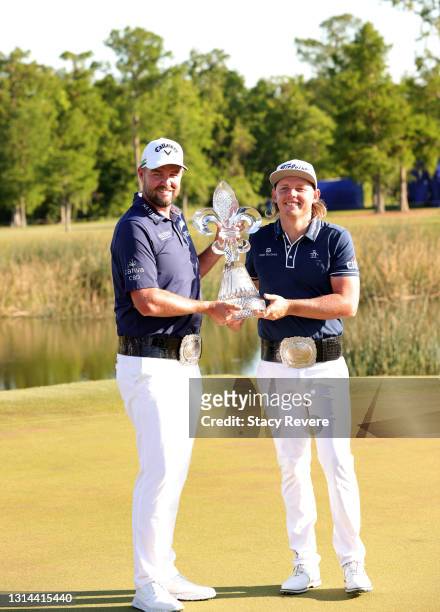 Marc Leishman of Australia and Cameron Smith of Australia pose with the trophy after winning in a playoff hole during the final round of the Zurich...
