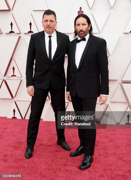 In this handout photo provided by A.M.P.A.S., Atticus Ross and Trent Reznor attend the 93rd Annual Academy Awards at Union Station on April 25, 2021...