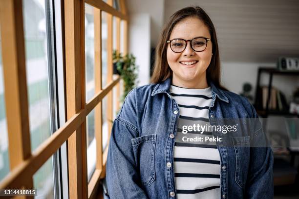 young woman posing in her small apartment - plus size model stock pictures, royalty-free photos & images