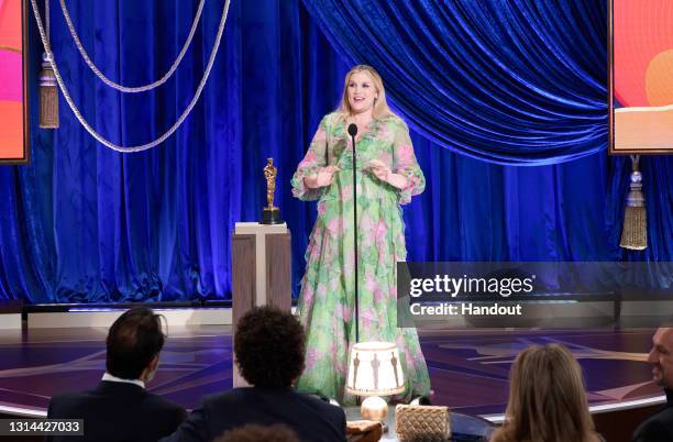 In this handout photo provided by A.M.P.A.S., Emerald Fennell accepts the Oscar® for Original Screenplay for "Promising Young Woman" onstage during...