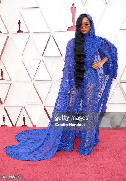 In this handout photo provided by A.M.P.A.S., H.E.R. Attends the 93rd Annual Academy Awards at Union Station on April 25, 2021 in Los Angeles,...