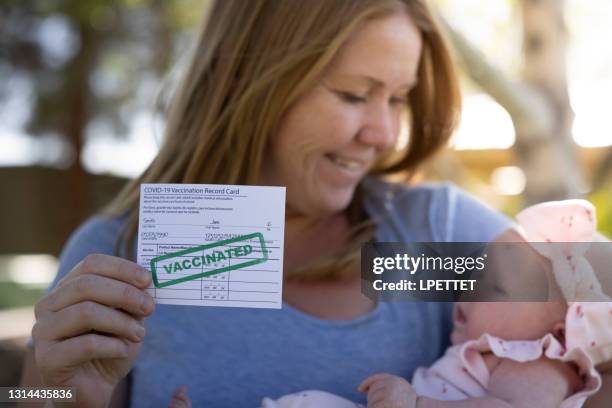 vaccination card - covid 19 vaccine card stock pictures, royalty-free photos & images