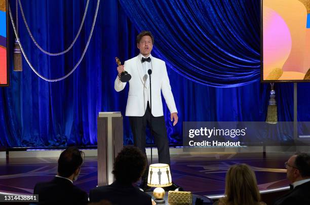 In this handout photo provided by A.M.P.A.S., Thomas Vinterberg accepts the International Feature Film award for 'Another Round' onstage during the...