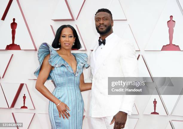 In this handout photo provided by A.M.P.A.S., Regina King and Aldis Hodge attend the 93rd Annual Academy Awards at Union Station on April 25, 2021 in...