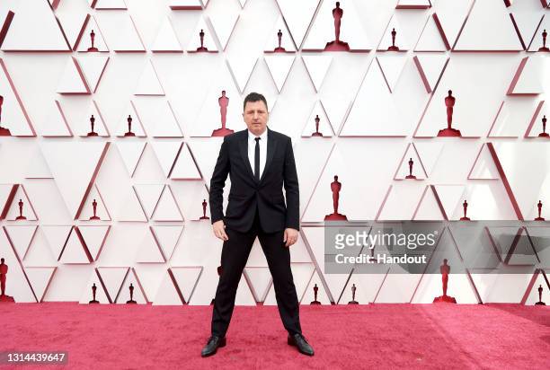In this handout photo provided by A.M.P.A.S., Atticus Ross attends the 93rd Annual Academy Awards at Union Station on April 25, 2021 in Los Angeles,...