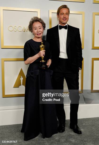 Yuh-Jung Youn, winner of Best Actress in a Supporting Role for "Minari," poses with Brad Pitt in the press room at the Oscars on Sunday, April 25 at...