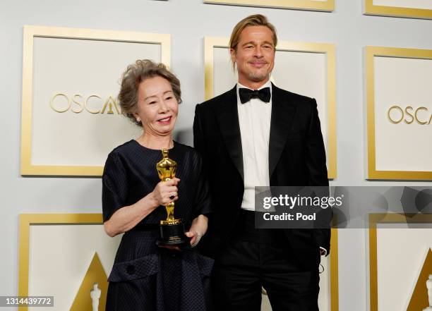 Yuh-Jung Youn, winner of Best Actress in a Supporting Role for "Minari," poses with Brad Pitt in the press room at the Oscars on Sunday, April 25 at...