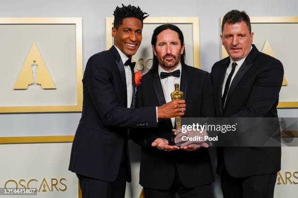 Jon Batiste, Trent Reznor, and Atticus Ross, winners of Best Original Score for "Soul," pose in the press room during the Oscars on Sunday, April 25...