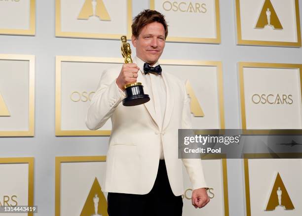 Thomas Vinterberg, winner of Best International Feature Film for "Another Round", poses in the press room during the Oscars on Sunday, April 25 at...