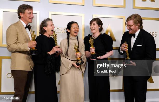 Peter Spears, Frances McDormand, Chloe Zhao, Mollye Asher, and Dan Janvey, winners of Best Picture for "Nomadland," pose in the press room at the...