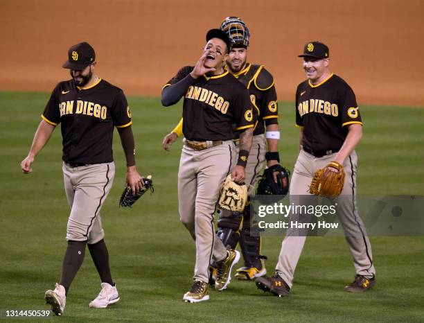 Eric Hosmer, Manny Machado, Victor Caratini and Mark Melancon of the San Diego Padres celebrate an 8-7 win over the Los Angeles Dodgers in eleventh...