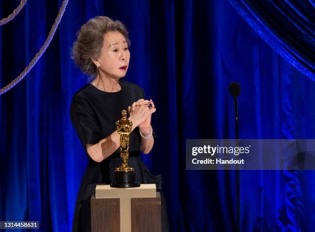 In this handout photo provided by A.M.P.A.S., Yuh-Jung Youn accepts the Oscar for Best Actress in a Supporting Role for "Minari" onstage during the...