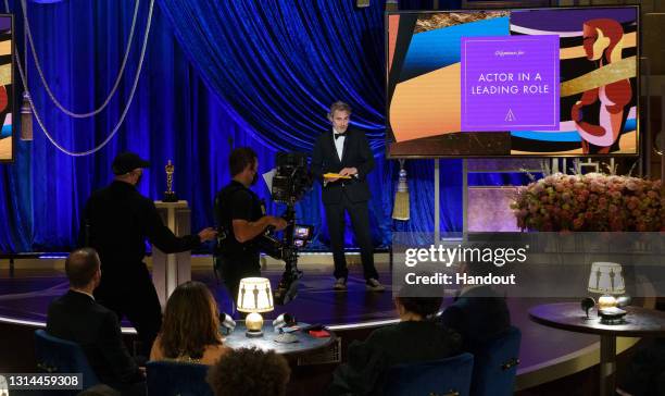 In this handout photo provided by A.M.P.A.S., Joaquin Phoenix presents the Oscar for Actor in a Leading Role the 93rd Annual Academy Awards at Union...