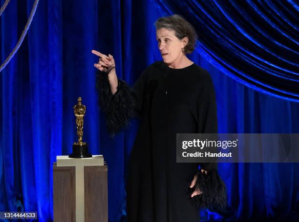 In this handout photo provided by A.M.P.A.S., Frances McDormand accepts the Oscar for Actress in a Leading Role for "Nomadland" the 93rd Annual...