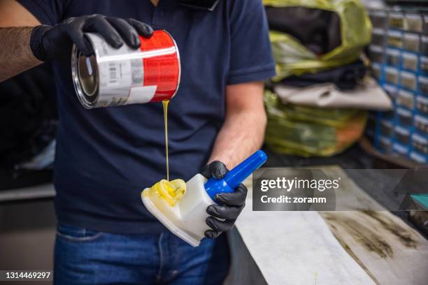 pouring glue into glue container - glue stock pictures, royalty-free photos & images