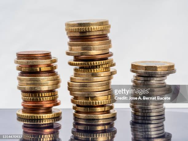 pile of savings coins on a white background. - inflation euro stock pictures, royalty-free photos & images