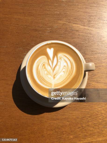 a table top photo of a latte taken from directly above with a smartphone camera. - latte art stock pictures, royalty-free photos & images