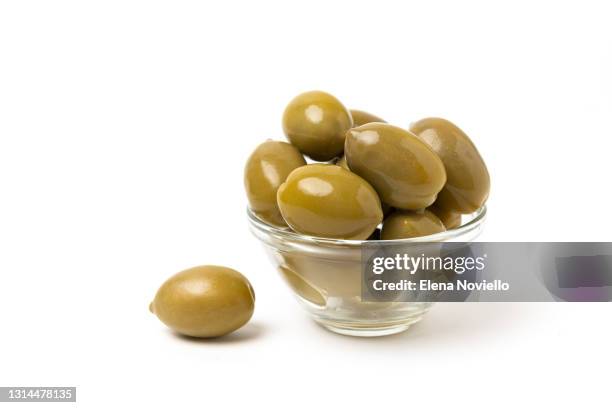 green olives isolated on white background - olive oil bowl stock pictures, royalty-free photos & images