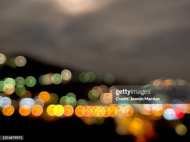 defocused city lights under moon - flare stack stock pictures, royalty-free photos & images