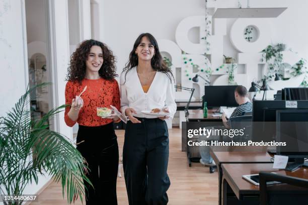 transgender business employee eating lunch on the move - colleagues luncheon stock pictures, royalty-free photos & images