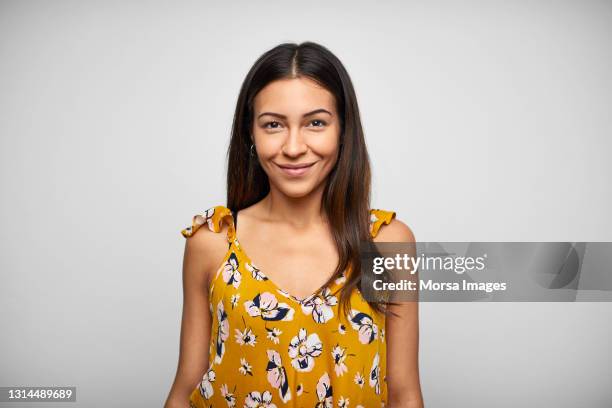 confident latin american woman against white background - cultura latino americana foto e immagini stock