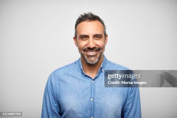 happy mature hispanic man against white background - studio portrait stock pictures, royalty-free photos & images